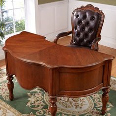 a large wooden desk sitting on top of a rug