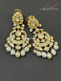 Silver Moissanite Polki Earring, Kundan Chandelier Bridal Jewelery, Traditional Jewelery 925 Silver Earring,18K Plated, Wedding Jewelery Statement Earring Drop Pearl Earring Material : Silver Gemstone: Moissanite, Drop Pearl Stone colour: Uncut Polki Primary colour: Gold Size-Length60mm Width:30mm Closure : Screw back and Clips Silver Intricate, hand crafted, Pure Silver Polki Earrings, studded with high quality Moissanite Polki comes with screw back and clips, made in 92.5 silver with 22ct gold Yellow Gold Chandbali Chandelier Earrings For Wedding, Festive Diamond Chandelier Earrings For Weddings, Luxury Rose Cut Diamond Chandelier Earrings For Wedding, Elegant Heavy Bridal Earrings For Reception, Traditional Bridal Earrings For Reception, Traditional Elegant Bridal Earrings For Reception, Elegant Hallmarked Kundan Jhumkas, Elegant Kundan Hallmarked Jhumkas, Diamond Chandelier Earrings In Yellow Gold For Wedding