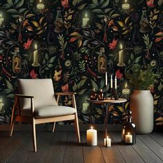 a chair and table with candles in front of a wallpaper