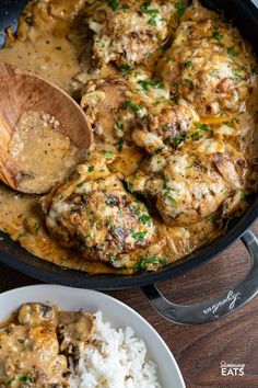 a skillet filled with meat and gravy next to rice