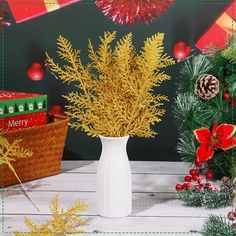 a white vase filled with yellow flowers next to pine cones and christmas decorations on a table