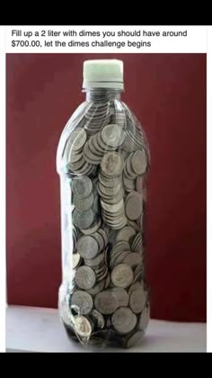 a bottle filled with coins sitting on top of a table