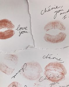 two pieces of paper with lipstick drawn on them