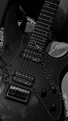 a black and white photo of an electric guitar