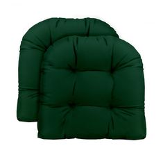 two dark green cushions sitting next to each other