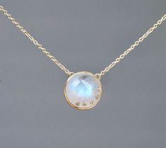 Lovely genuine AA blue moonstone is set in 14k gold. A very unique necklace where the moonstone itself is studded with diamonds in a stone on stone setting.  Size : 12mm Metal : 14kt Gold (choose color from dropdown) Gemstones : 13 cts Rainbow Moonstone 0.03 cts F, SI White Diamonds Packaging : All products purchased from us come in a gift box. If you need to include a message, kindly leave us a note when purchasing.  Care Recommendations:  Opal jewelry can be cleaned at home by using a soft clo Fine Jewelry With Single Cut Diamonds And Moonstone, White Moonstone Jewelry With Single Cut Diamonds, Moonstone Necklaces With Gemstone Accents, Round Moonstone Necklace With Gemstone Accents, June Birthstone Jewelry, Blue Moonstone, June Birthstone, Unique Necklace, Stone Setting