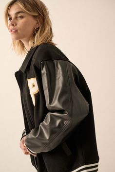 Felt and faux leather varsity bomber jacket. Flowers and letter "P" chenille applique patches. Contrasting faux leather sleeves. Side pockets with faux leather trim. Collared neckline. Zip-up front closure with snaps at top and bottom. Long sleeves. Dropped shoulders. Striped ribbed knit cuffs and hem. Yoke back. Quilted lining. Loose fit. 80% Polyester, 20% Cotton. Imported. Designed in LA. Model wears size S. Tulle Sleeve Top, Def Leppard Love Bites, Chenille Applique, Applique Patches, Leather Sleeves, Letter P, Home Team, Leather Sleeve, Vintage Canvas