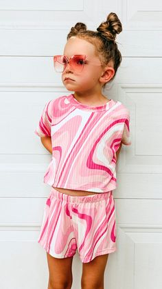 This beautiful groovy pink swirl outfit is sold as a set. Comes with a short sleeved  crop top and a pair of breezy shorts. Made with soft and stretchy yummy rib knit fabric that is so comfy for your girl to wear all summer long!  ➡️If you would like a custom length tee and not a cropped tee, please choose "Custom Size" and in the notes section at checkout, please provide me with the length of the tee that you want from the center back neck down to the hem.  Sizes are: XSmall (6-12mo) Small (12- Playful Pink Short Set With Short Sleeves, Playful Pink Short Sleeve Short Set, Cute Matching Set Tops For Vacation, Multicolor Short Sleeve Short Set For Spring, Pink Cotton Short Set For Beach, Cute Pink Short Set For Summer, Spring Playwear Short Set, Spring Short Set For Playwear, Playful Short Tops For Spring