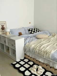 a bedroom with a bed, bookcase and rugs