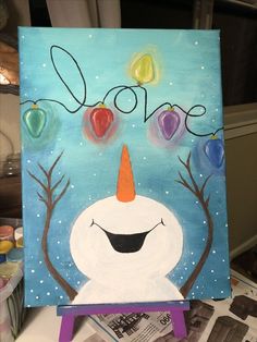 a painting of a snowman with trees and hearts on his head, in the middle of an art project