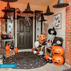 a front porch decorated for halloween with pumpkins and decorations