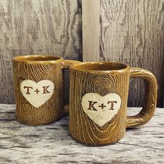 two wooden mugs with initials on them