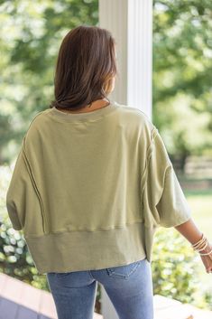 Mineral washed olive green french terry knit pullover top with hi-low bottom hem Sass up your casual attire with our Sunset Ready Washed Olive Top! This fun, comfy top features french terry knit fabric, wide 3/4 length sleeves, and a split hi-low bottom hem. Perfect for adding a quirky twist to any casual day out! Relaxed fit; semi-cropped Model is 5'5" wearing a small Fabric contains stretch Ribbed distressed crew neckline Wide 3/4 length sleeves with drop shoulder Front side slits and distress Trendy Soft-washed French Terry Tops, Casual French Terry Tops For Layering, Casual French Terry Tops, Oversized Olive Top For Fall, Oversized Olive Cotton Top, Casual French Terry Top With Drop Shoulder, Casual French Terry Drop Shoulder Tops, Oversized Relaxed French Terry Top, Oversized French Terry Top For Spring