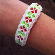 a close up of a person's arm wearing a bracelet with beads on it