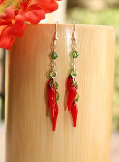 "Chili pepper lovers, these funky earrings are a must for you I created these sassy, red earrings are handcrafted of red and green glass lamp work beads that suspend from a Swarovski crystal. These cute earrings make the perfect unique gift! You can customize these food earrings to suit your personal style and budget with your choice of sterling silver, 14k gold filled, gold plated, or silver-plated material. D E T A I L S * Earring Length: 2\" (not including ear wire) * Metal Choices: 100% 14k Red Novelty Drop Earrings, Nickel Free Novelty Earrings For Party, Fun Nickel-free Dangle Earrings, Novelty Red Pierced Earrings, Fun Nickel Free Drop Earrings, Fun Nickel-free Drop Earrings, Handmade Fun Red Earrings, Novelty Drop Earrings For Party, Fun Drop Earrings With Ear Wire