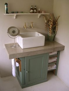 a bathroom sink sitting on top of a wooden counter