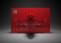 a red credit card sitting on top of a table