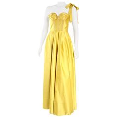 Rochas rich yellow gown in satin fabric with tie shoulder and structured bodice. Reminiscent of Belle's gown from Beauty and the Beast. Size IT 40/ US 4. Luxury Satin Finish Party Gown, Luxury Satin Finish Gown For Party, Strapless Evening Gown With Bow, Silk Evening Gown With Boned Bodice, Silk Ball Gown For Gala, Silk Gown With Fitted Bodice For Evening, Silk Gown With Boned Bodice For Evening, Gold Silk Gown For Formal Occasions, Sleeveless Evening Dress With Satin Bow