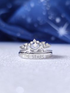 two wedding rings with the words, the stars were written on them