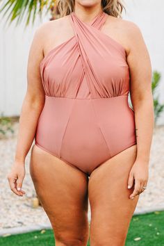 This swimsuit is perfect for your next beach trip! This swimsuit has a shimmery pink color that's perfect for the season! It has a classic one-piece fit, features a tied crisis cross halter neckline bust! Wear this swimsuit to every pool party on your calendar this Summer! 82% Polyamide, 18% Elastane Solid Color Cross-tied Swimwear For Summer, Cross-tied Halter Neck Swimwear For Beach Season, Crisscross Strap Halter Top For Beach Season Pool, Crisscross Straps Halter Top For Beach Season, Cross-tied Swimwear For Swimming, Halter Top With Crisscross Straps For Beach Season, Pink Crisscross Strap Beachwear Swimwear, Pink Crisscross Straps Swimwear, Solid Cross-tied Swimwear For Poolside