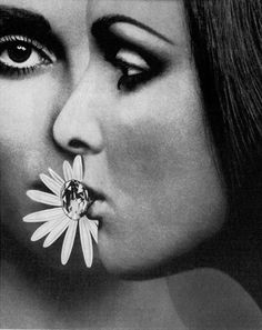 an old photo of a woman with a flower in her mouth and nose piercings