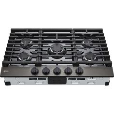 a gas stove top with four burners on it