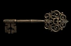 an old key with ornate design on it is shown in the middle of a black background