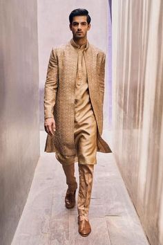 Beige long jacket with geometric motif hand embroidery. Comes with kurta and cigarette pant.
Component: 3
Pattern: Embroidered
Type Of Work: Geometric Motifs
Neckline: Mandarin Collar
Sleeve Type: Full
Fabric: Jacket and Kurta: Bamberg, Pant: Cotton Satin
Color: Beige
Other Details: 
Full sleeve jacket
Side slits
Front concealed button placket kurta
Occasion: Groom, Wedding - Aza Fashions Collar Kurta, Men Kurta, Sherwani For Men, Kurta Set For Men, Beige Jacket, Indian Couture, Satin Pants, Geometric Motifs, Nehru Jackets