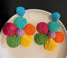 With a distinct 60's flower child vibe, these fun and brightly hued earrings are raffia over brass and sway nicely when you move your head.  Mint, hot pink, neon orange, bright yellow, sage and turquoise colors.  Lightweight, post back.  A 2 ¾" dangle length. 28-116 Handmade Multicolor Flower Earrings For Spring, Multicolor Flower Earrings For Beach, Beach Flower Earrings In Multicolor, Colorful Flower Earrings For Spring, Spring Rainbow Earrings, Playful Multicolor Handmade Flower Earrings, Playful Handmade Multicolor Flower Earrings, Summer Multicolor Handmade Flower Earrings, Handmade Playful Earrings For Spring