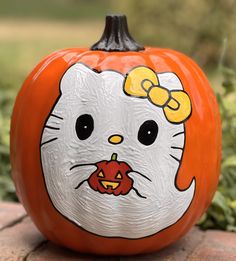 a hello kitty pumpkin with a bow on it