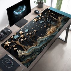 a computer desk with an artistic design on the top and gold stars in the middle