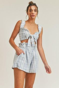 STYLE INFORMATION: Your look will be totally on-trend with the Beach House Blue and White Striped Two-Piece Romper! Lightweight cotton fabric (in a blue and white striped print) shapes this set. Sleeveless crop top with smocked back and matching shorts with elastic paper bag waistband short with side pockets set. Shorts are lined. DETAILS & CARE: Cotton. Machine Wash Cold. Imported. SHIPPING: Orders are processed within 1-2 business days. Packages are shipped out Monday-Friday, holidays are excl Chic Striped Crop Top For Vacation, Striped Cropped Top For Day Out, Chic Striped Summer Crop Top, Striped Crop Top For Day Out, Chic Striped Crop Top For Summer, Blue Crop Top For Summer Loungewear, Striped Crop Top For Summer Vacation, Striped Sleeveless Crop Top For Day Out, Cropped Cotton Crop Top For Beach Season