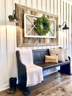 a wooden bench sitting in front of a wall with a wreath on top of it