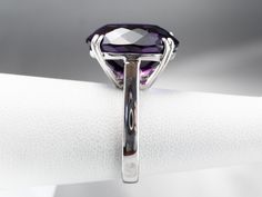 This exceptional amethyst commands attention! Generous in size, this gemstone sparkles with juicy hues of violet, fuchsia, and royal purple. A simple setting of 18 karat white gold lets the amethyst be the star of the show. Metal: 18K White Gold Gem: Amethyst 12.20 Carats Gem Measurements: 12.9 x 16.9 mm, Oval Ring Size: 6.25 Marks: "750" Stamped on the inside band Luxury Faceted Amethyst Ring For Formal Occasions, Luxury Faceted Amethyst Ring For Formal Events, Faceted Purple Amethyst Ring For Formal Occasions, Formal Faceted Purple Amethyst Ring, Formal Faceted Amethyst Ring Fine Jewelry, Formal Faceted Amethyst Ring, Modern Sterling Silver Amethyst Ring For Formal Occasions, Luxury Purple Amethyst Ring In Platinum, Elegant Faceted Purple Rings