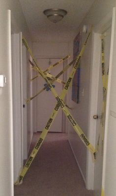 a hallway with yellow caution tape on the floor