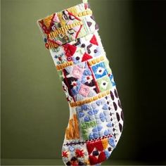 a multicolored christmas stocking hanging from a hook