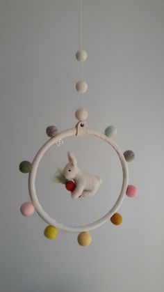 a stuffed animal is hanging from a circular mobile