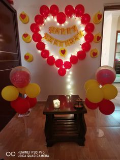 balloons are arranged in the shape of a heart on display at a birthday party for someone's special occasion