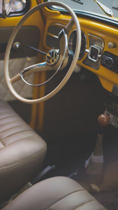 the interior of an old fashioned car with tan leather seats and steering wheel, showing the dashboard