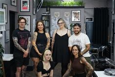 a group of tattooed people posing for a photo