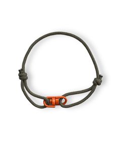 Discover the perfect accessory to complement your laid-back style Unisex Adjustable Cord Bracelet with contrasting coloured metal swivel connector. The bracelet features a durable, high-quality genuince paracord construction. The materials are meticulously selected to ensure long-lasting wear, making it a robust companion for your adventures or daily activities. One of the standout features of this bracelet is its adjustability. The sliding knot design provides flexibility in size, making it easy to get the perfect fit. Whether you prefer a snug or relaxed fit, this bracelet adjusts to your preference, making it comfortable to wear all day long. Ideal for wearing everyday or adding a unique touch to formal wear, this cord bracelet transitions effortlessly from day to night. Its versatile d Adjustable Durable Bracelet For Outdoor, Durable Adjustable Bracelet For Outdoor, Minimalist Adjustable Durable Bracelet, Adjustable Green Bracelets For Outdoor, Adjustable Cord Bracelet, Knot Design, Cord Bracelet, Unisex Bracelets, Sliding Knot