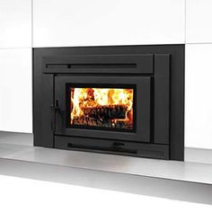 a fire burning in a fireplace with white walls