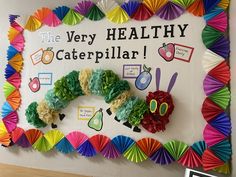 the very healthy caterpillar bulletin board is decorated with colorful paper flowers and scissors