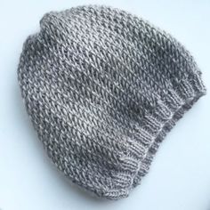 a knitted hat sitting on top of a white plate