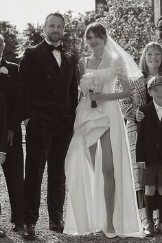 the bride and groom are posing with their children