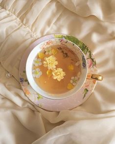 a cup of tea with flowers in it