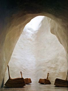 two wicker baskets sitting in the middle of a tunnel