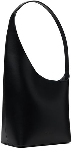 Buffed calfskin shoulder bag in black. · Integrated shoulder strap · Logo embossed at face · Magnetic closure at asymmetric throat · Patch pocket at interior · Buffed faux-leather lining · H14 x W9.5 x D4 · Total height: H16 Supplier color: Black Luxury Evening Hobo Bag With Single Shoulder Strap, Black Textured Leather Structured Shoulder Bag, Black Structured Textured Leather Shoulder Bag, Structured Black Textured Leather Shoulder Bag, Sleek Evening Hobo Bag, Modern Faux Leather Shoulder Bag For Evening, Evening Hobo Bag With Single Shoulder Strap In Black, Evening Black Hobo Bag With Single Shoulder Strap, Modern Evening Faux Leather Shoulder Bag