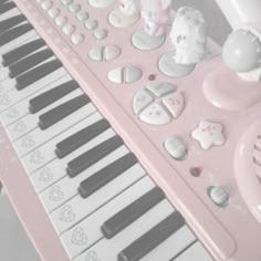 a pink piano with lots of hearts and other decorations on it's keyboard top