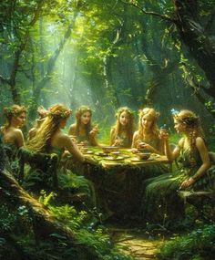 a group of women sitting around a table in the middle of a lush green forest